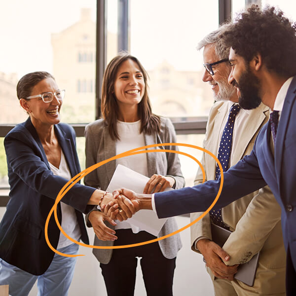 Professionals shaking hands in an office.